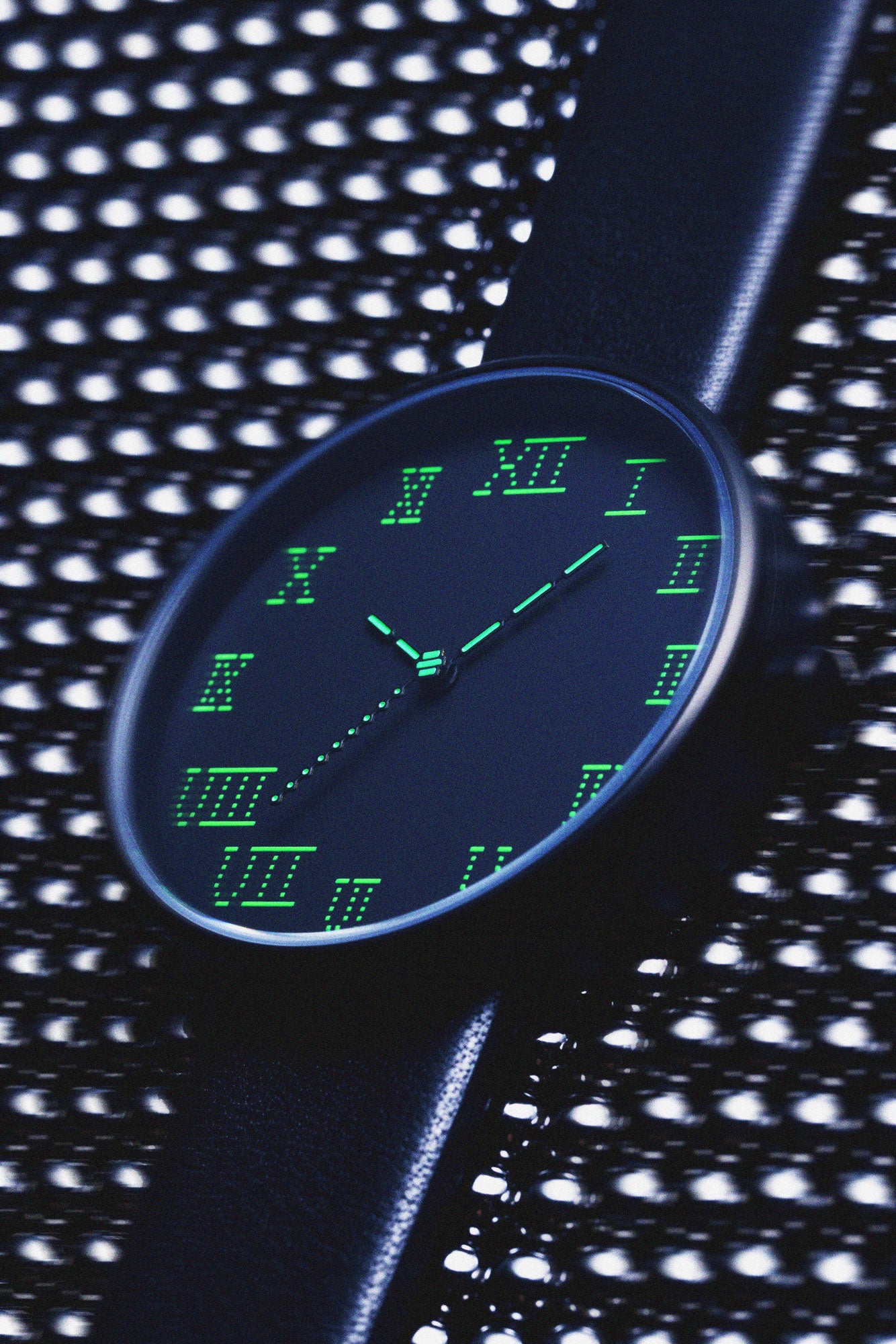 Showcasing the front of the TTT - ACTUAL SOURCE - THERMAL watch against a metallic sphere background.