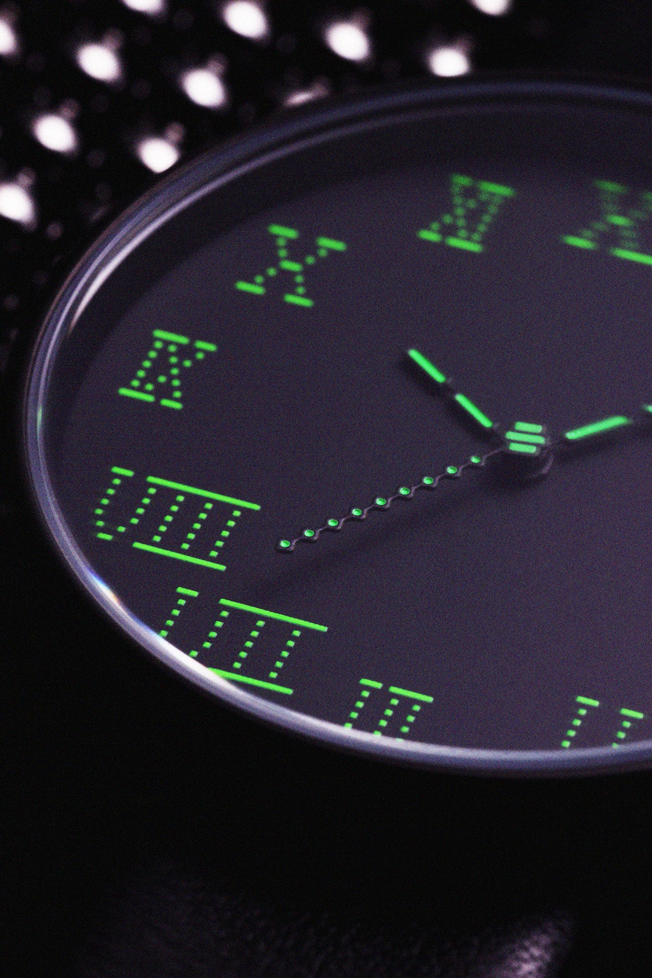 Presenting a close-up view of the dial on the front of the TTT - ACTUAL SOURCE - THERMAL watch, showcased against a backdrop of metallic spheres.