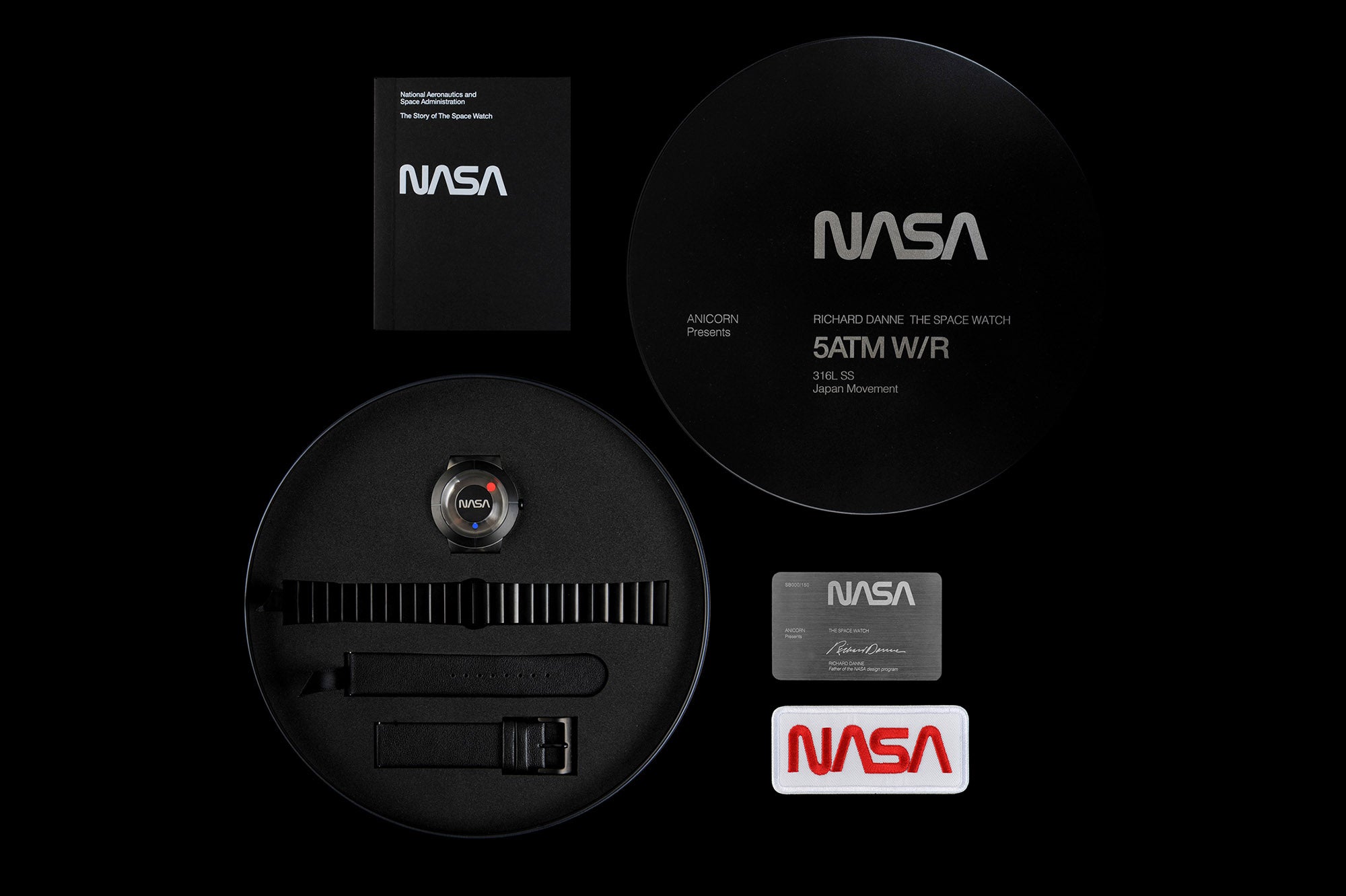 The Space Watch by Richard Danne set with NASA booklet, packaging, extra straps, and a metal card, all emblazoned with NASA branding on a dark surface.