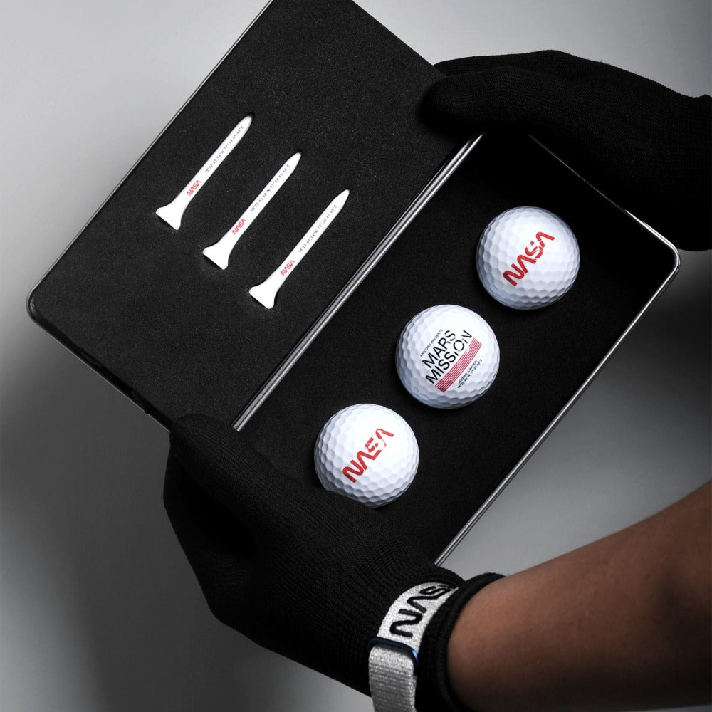 The Mars Swing golf set comes in three balls featuring NASA’s worm logo and three tees printed with coordinates of Jezero Crater in a premium metal case.