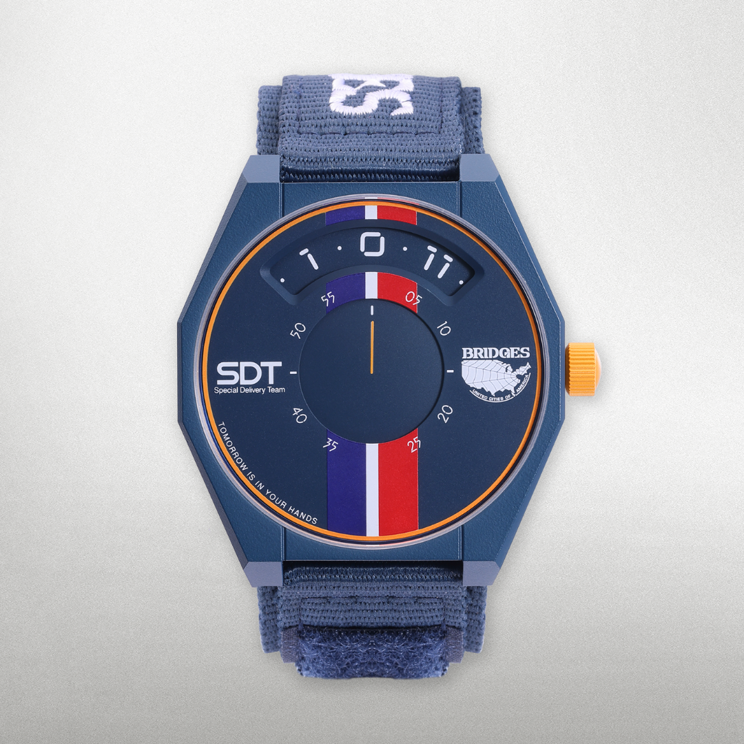 Presenting the DEATH STRANDING X ANICORN - Reverse Trike Time Limited Edition with a white background, featuring a nylon strap adorned with the Bridges logo embroidery.