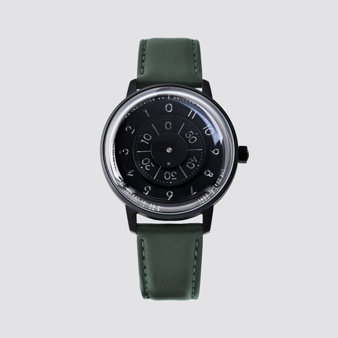 Anicorn K452 Nemesis black watch with a rotating disc dial and green leather strap.