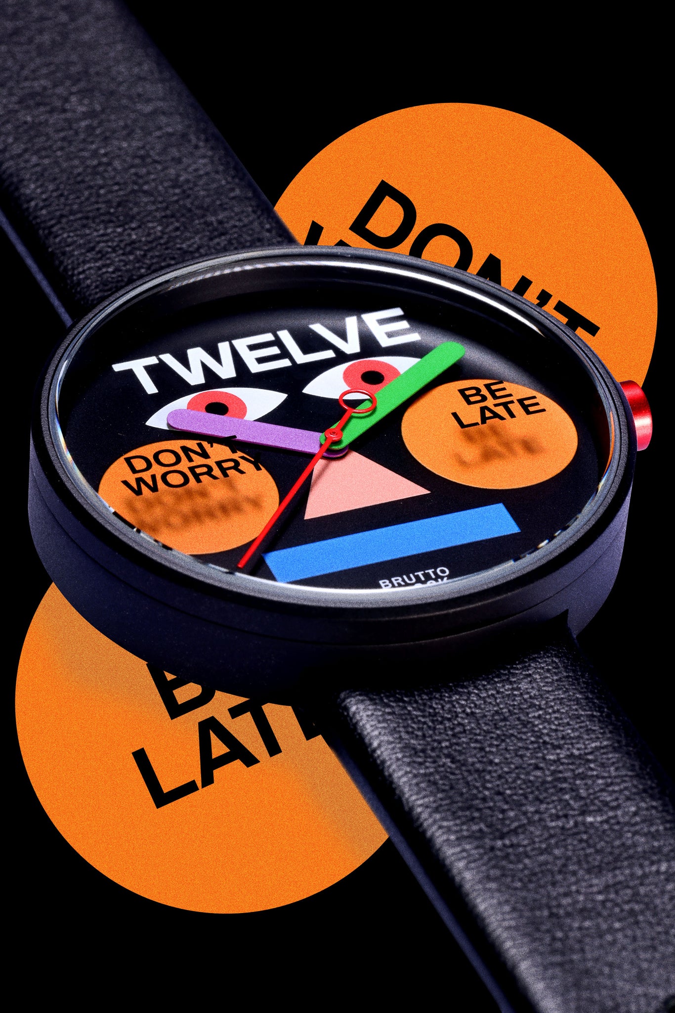 Showcasing the front of the TTT - Brutto Studio - Be Late watch against with be late element background.