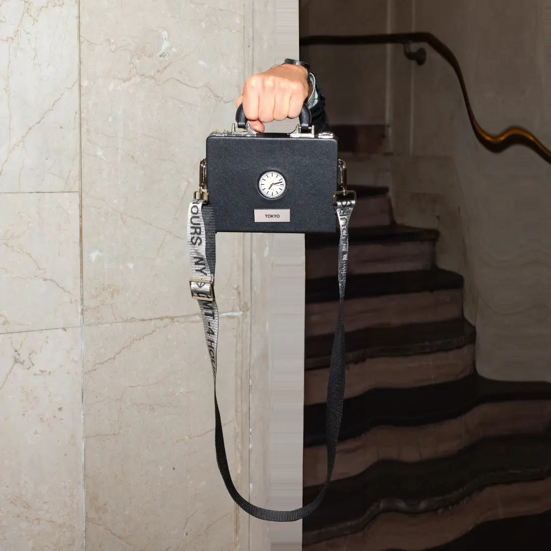 A bag with strap, from TTT - The Time Traveler Watch by Nik Bentel Studio
