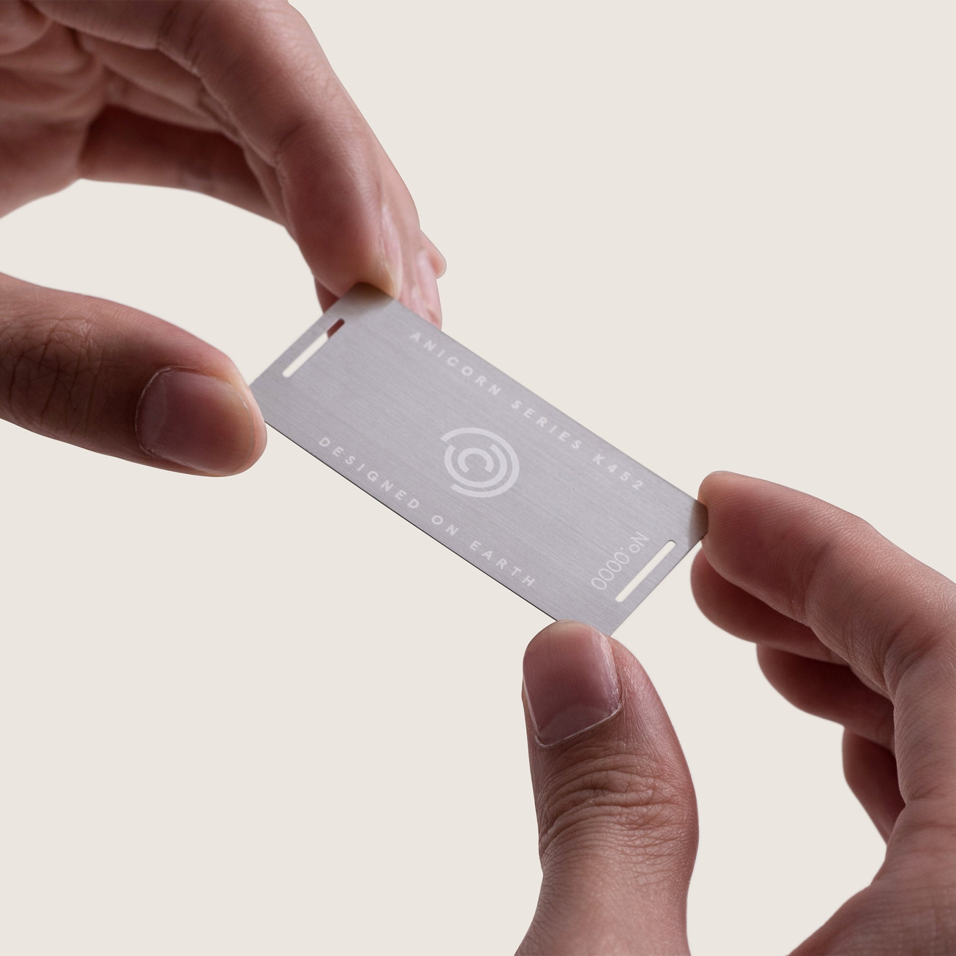A laser-engraved metallic card that serves as a document for warranty. The plate is uniquely numbered and issued. 