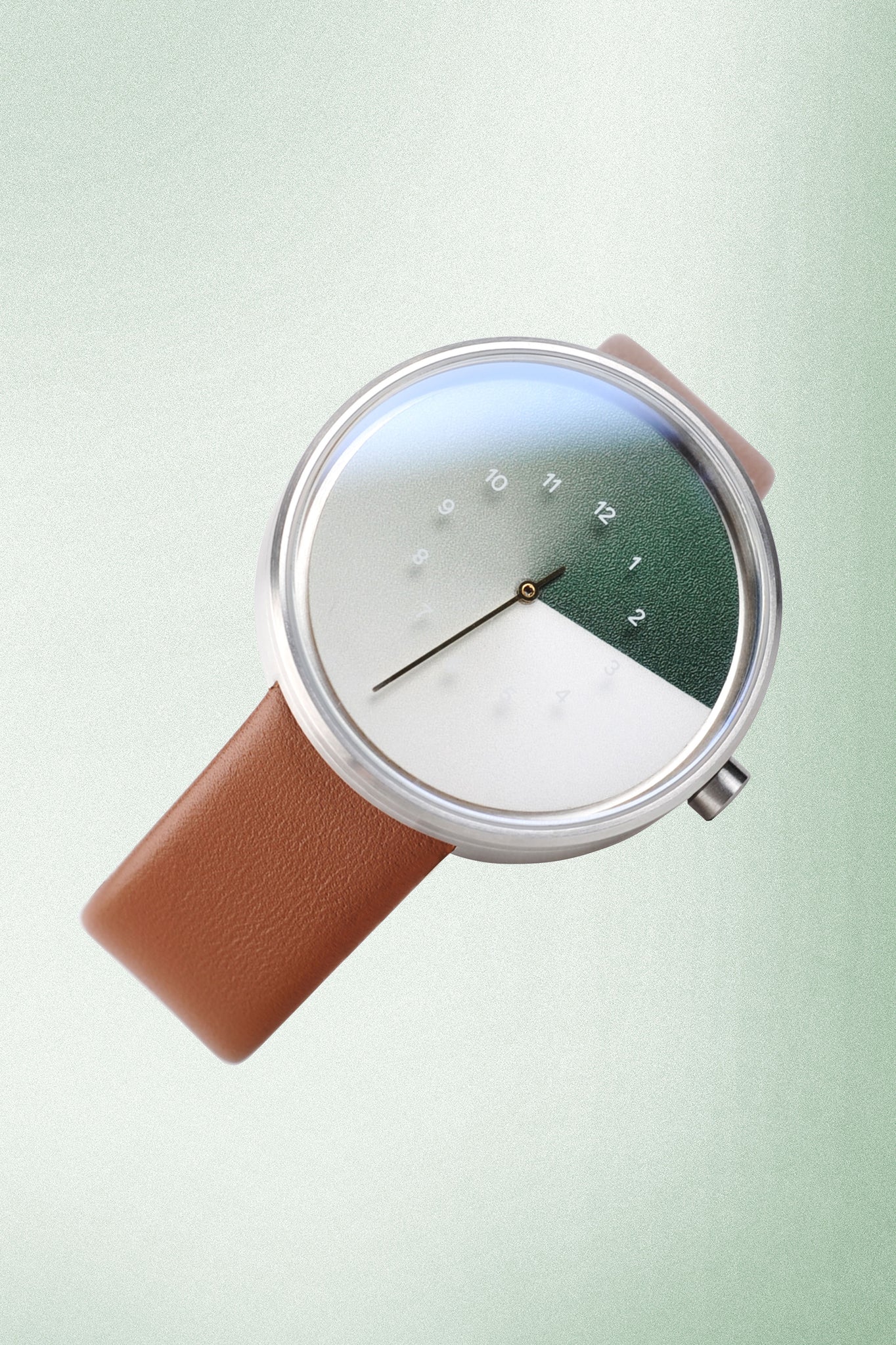 TTT#1 - Seoul - Hidden Time Watch - Olive is a stunning timepiece that features a sleek green watch face set against a light green background, accented by rich brown straps