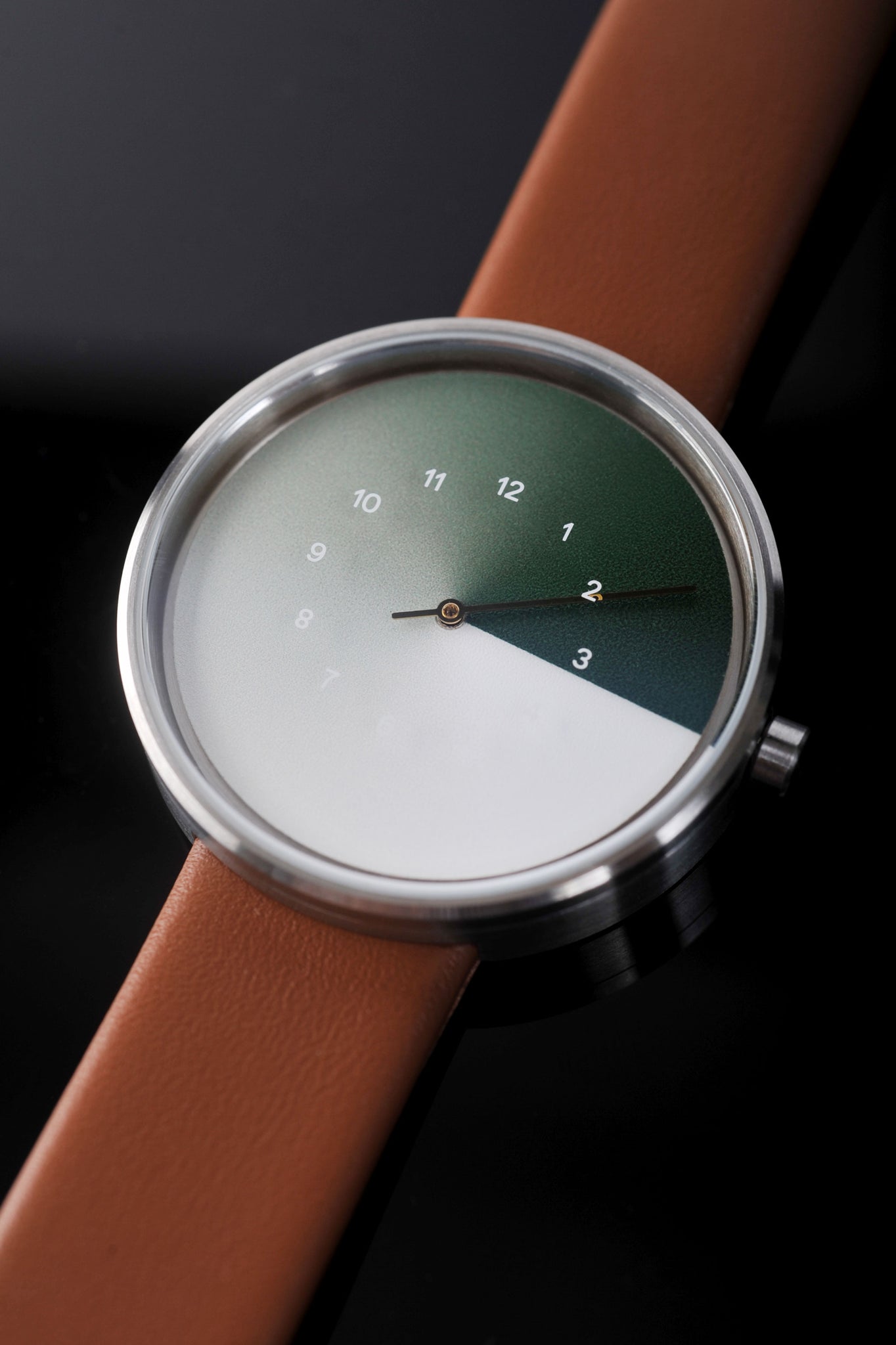 This is a wide shot of the TTT#1 Seoul Hidden Time Watch in Olive. The image showcases the intricate details and sleek green watch face of this high-quality timepiece