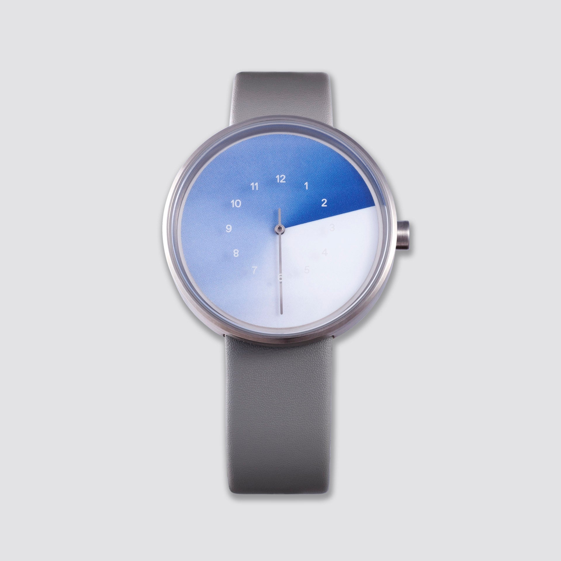Front view of the TTT#1 - Seoul - Hidden Time Watch - Azure against a sleek gray background, showcasing the watch's signature gradient design that reveals the white hour numerals printed on the glass above