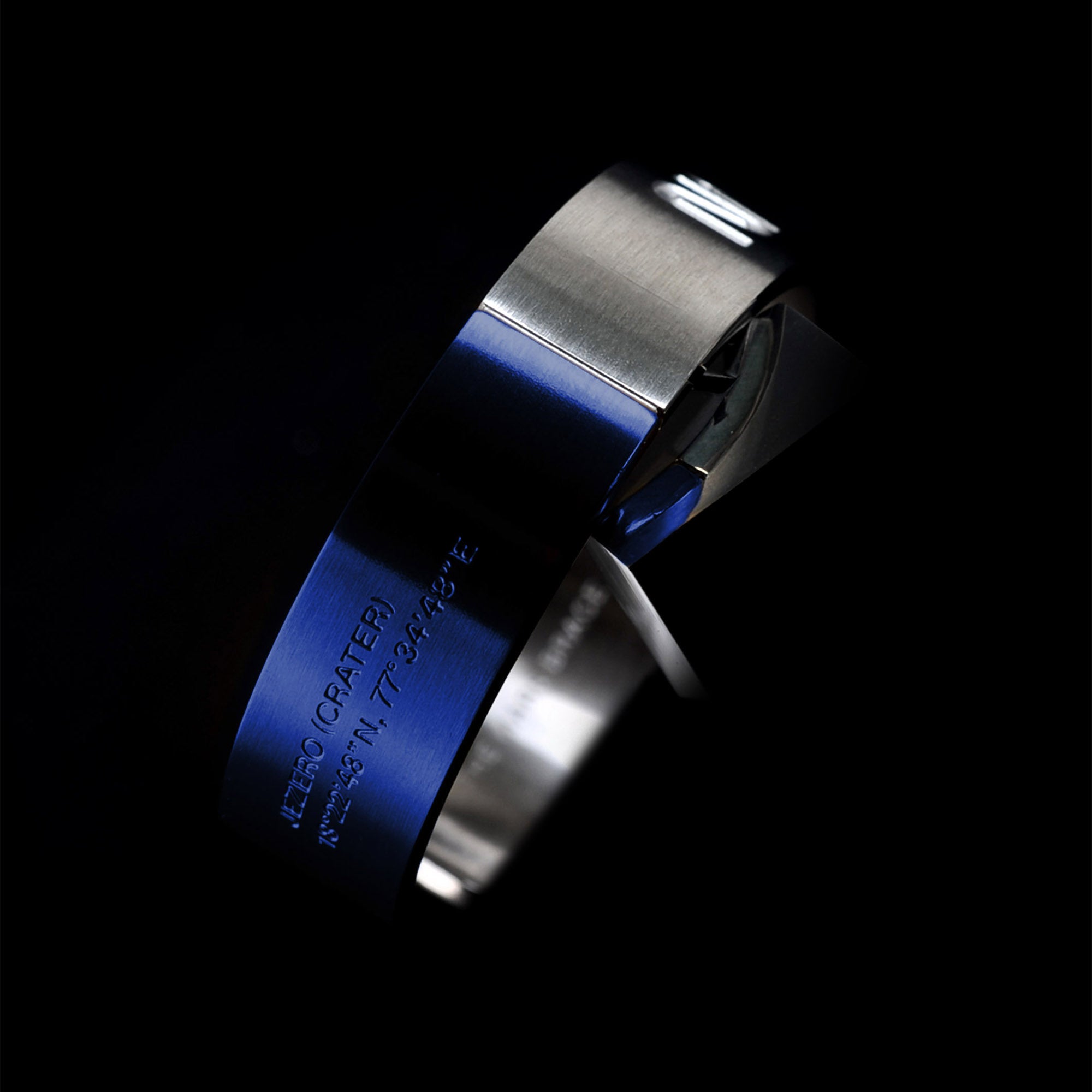 Futuristic elegance. A slip-on gold/silver or blue/silver duo-colored stainless steel bracelet with the landing coordinates and NASA logo embossed. A collaboration with Shannnam.