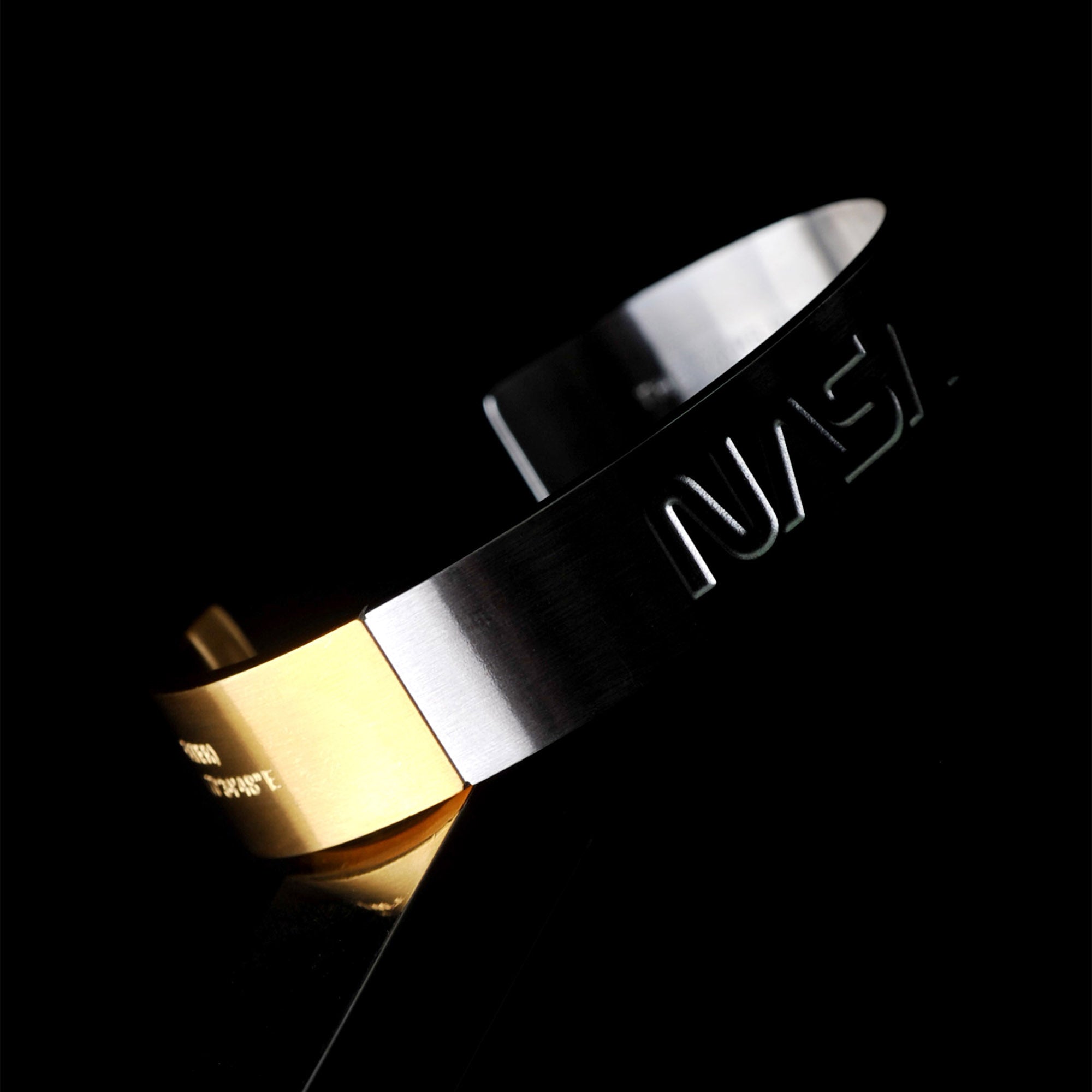 Futuristic elegance. A slip-on gold/silver or blue/silver duo-colored stainless steel bracelet with the landing coordinates and NASA logo embossed. A collaboration with Shannnam.