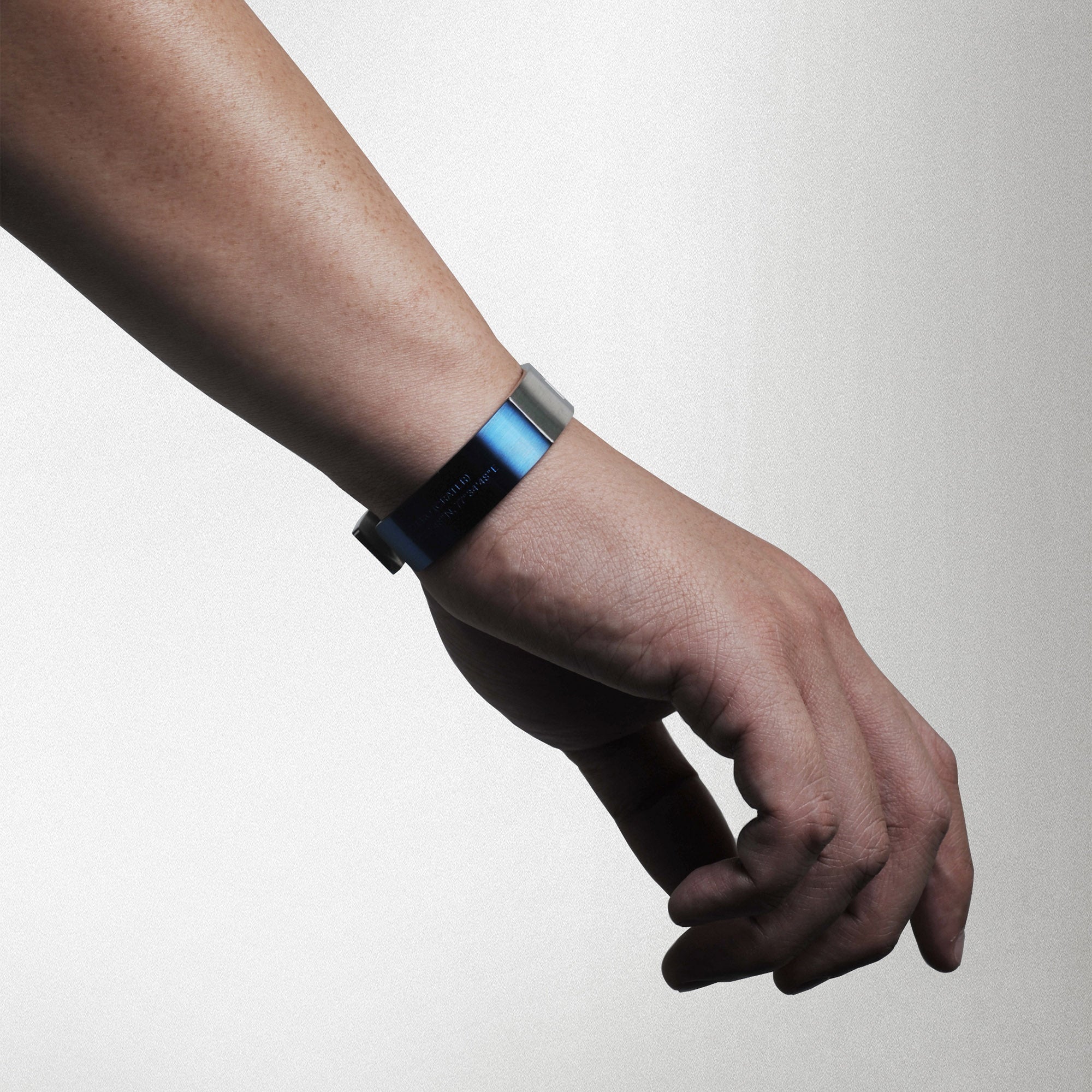 Futuristic elegance. A slip-on gold/silver or blue/silver duo-colored stainless steel bracelet with the landing coordinates and NASA logo embossed. A collaboration with Shannnam.